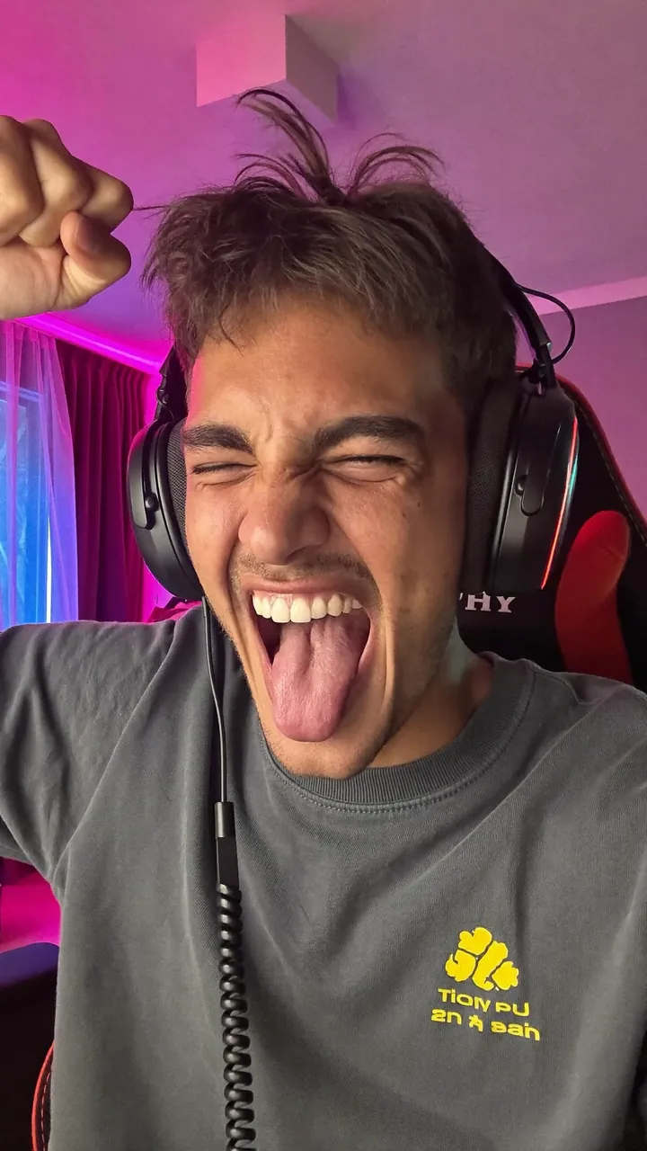 Gaming reel still: a streamer in headphones shouting at the camera.